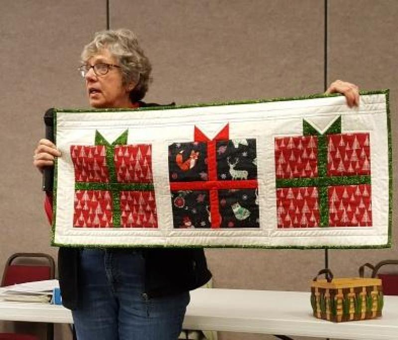 Peggy has made a table runner: Christmas Present, for our silent auction